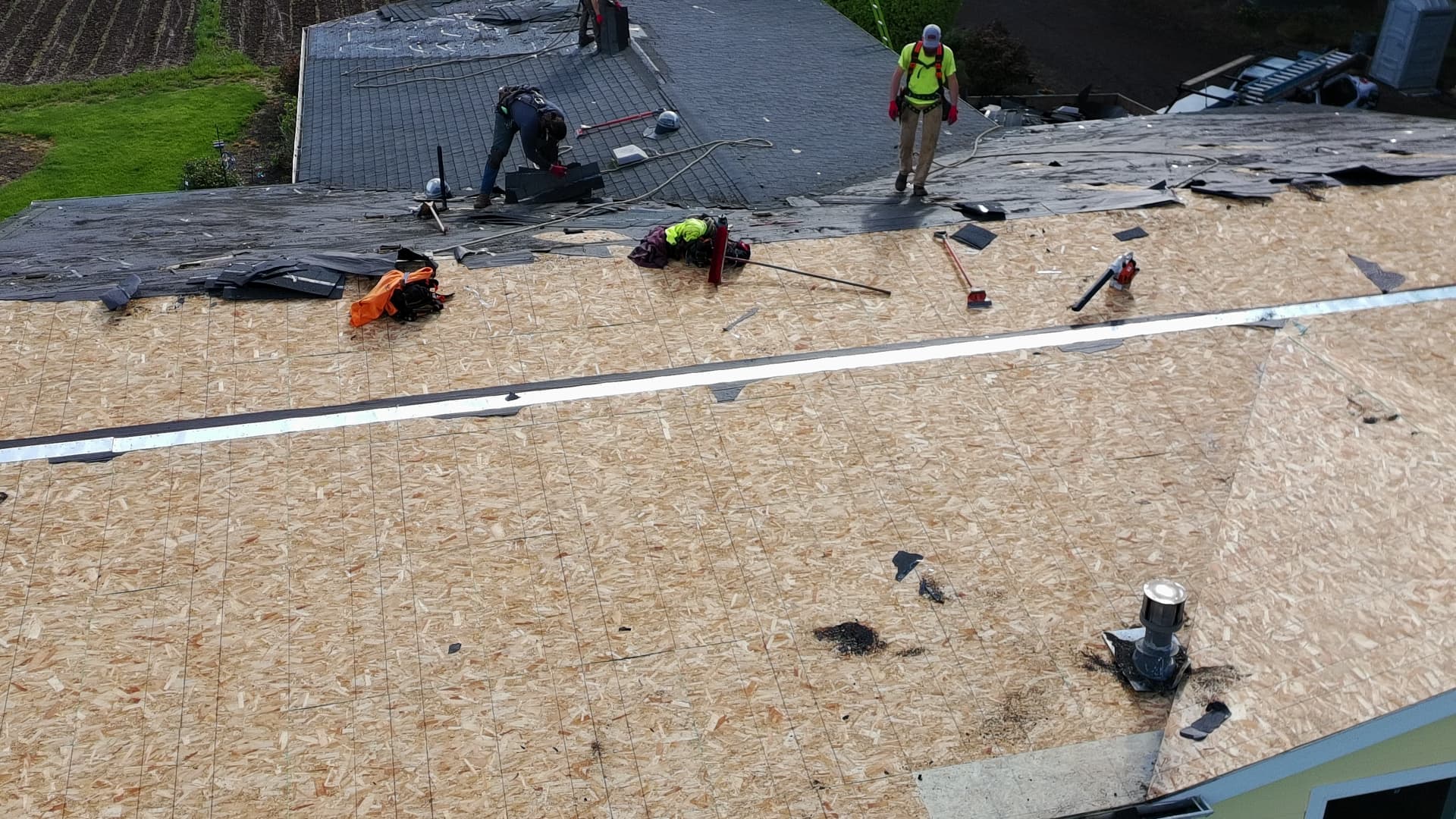 Exposed roof decking with new sheathing installed during a full roof replacement